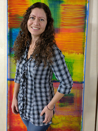Artist Wendi La Fey with painting, "Fire Dance"