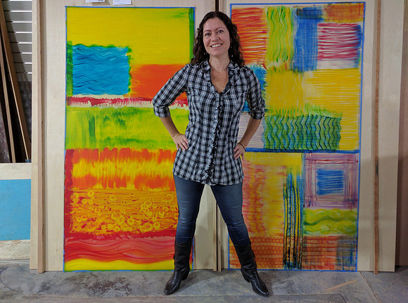 Artist Wendi La Fey with painting, "Fire Dance" showing the 2 layers before they are combined.